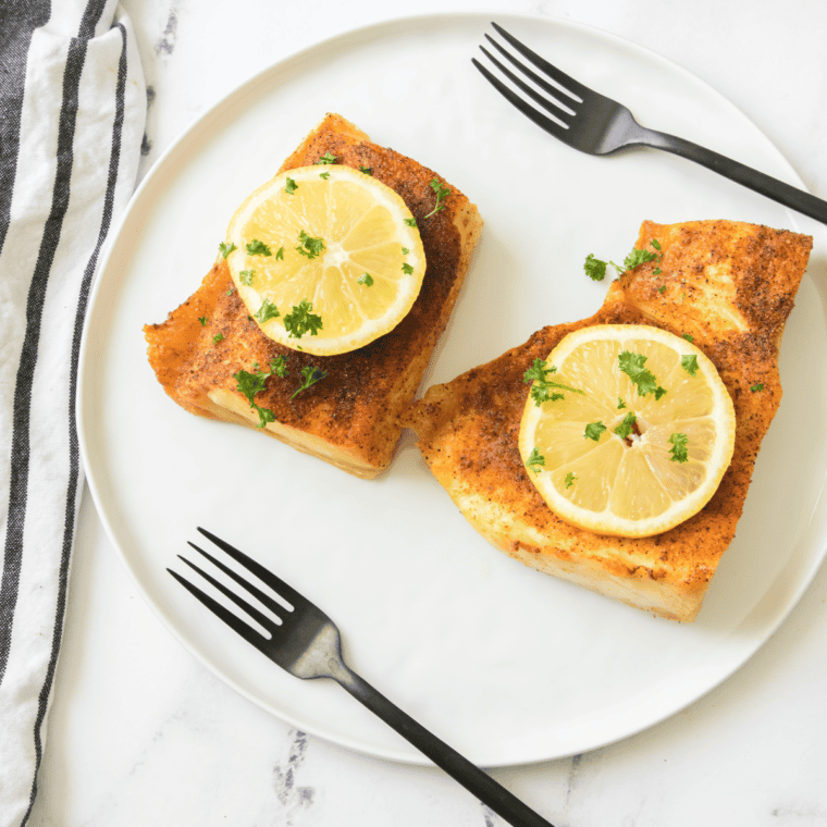 Golden-crusted Air Fryer Halibut fillets, crispy on the outside and tender inside, ready to enjoy.