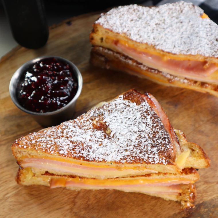 "Air Fryer Monte Cristo Sandwich: Crispy exterior, filled with ham, turkey, and melted cheese, served with raspberry jam."