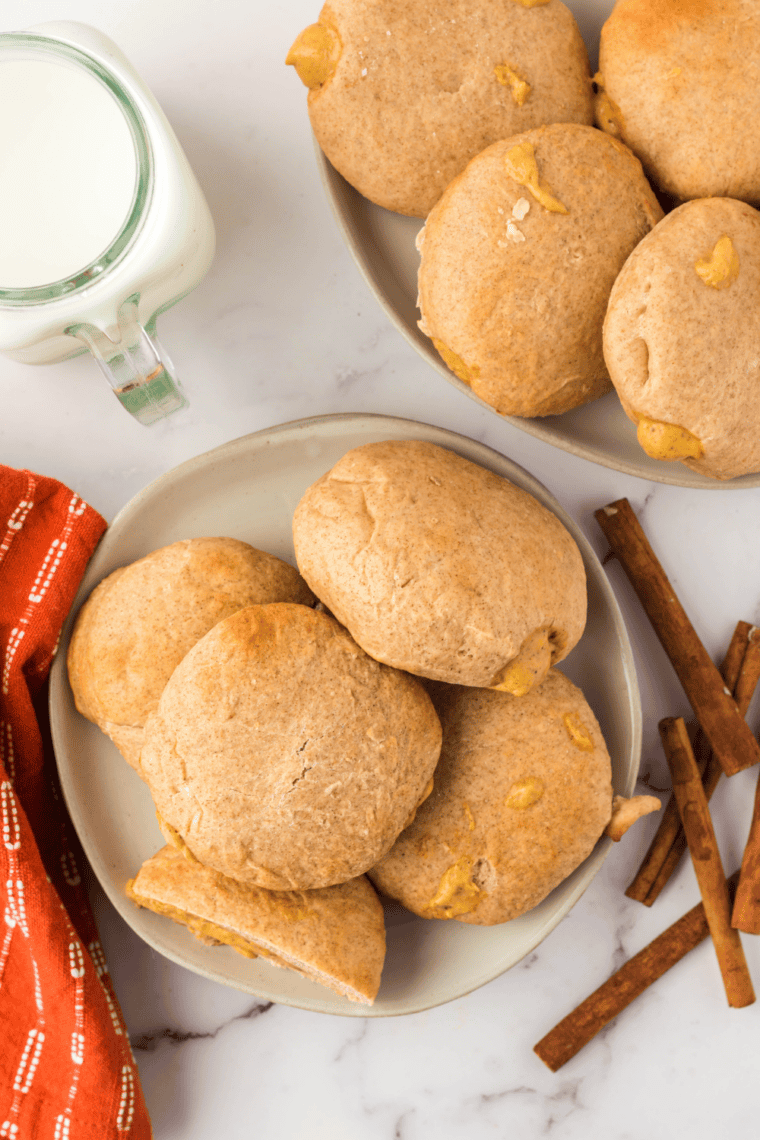 Golden air fryer pumpkin donuts filled with smooth, creamy pumpkin custard, served on a plate.