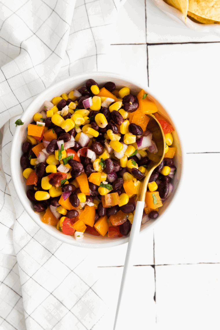 Fresh Applebee’s black bean and corn salsa served in a white bowl with tortilla chips