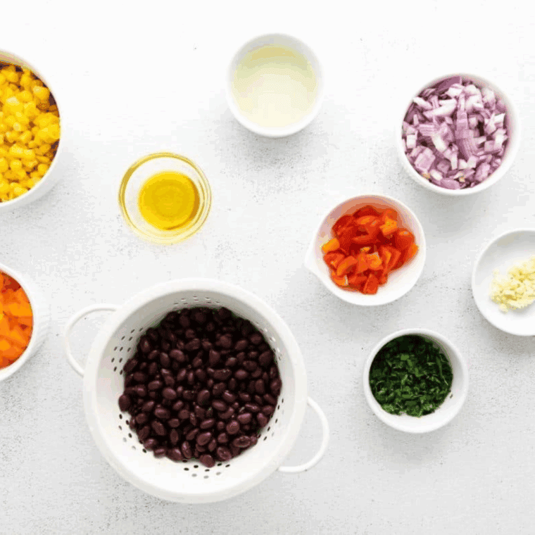 Ingredients needed for Applebee’s Black Bean and Corn Salsa Recipe on kitchen table.