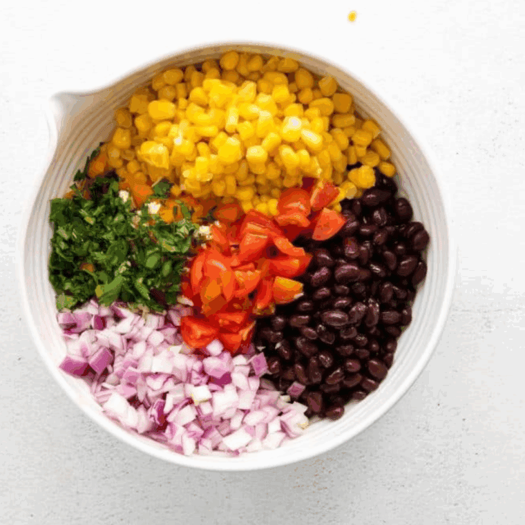 Add all of the ingredients for Applebee’s Black Bean and Corn Salsa Recipe in a mixing bowl.