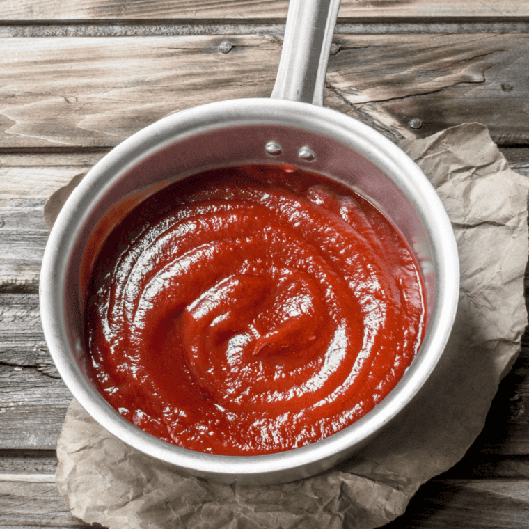 Simmering Arby’s Three Pepper Sauce in a saucepan to meld flavors, ready to serve with sandwiches, fries, or chicken tenders.