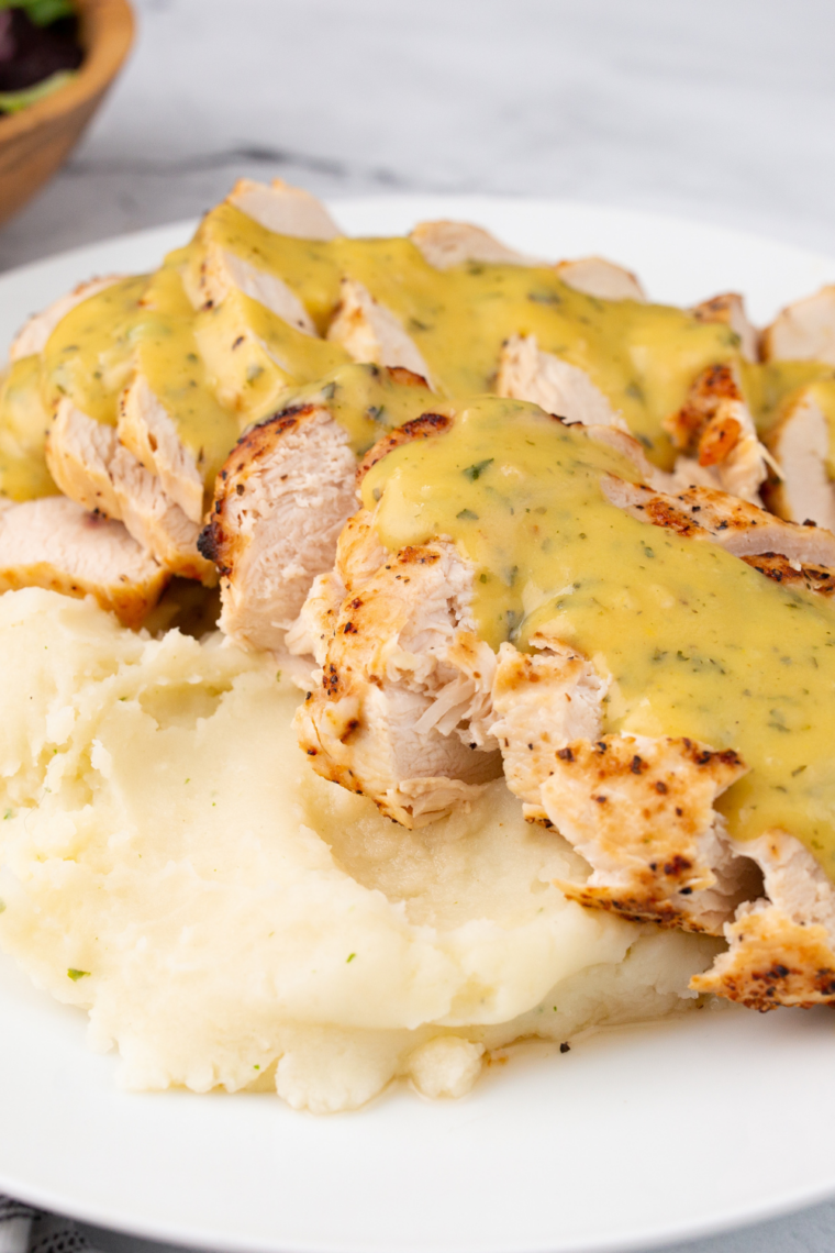 Jar of creamy copycat KFC honey mustard sauce with honey dipper