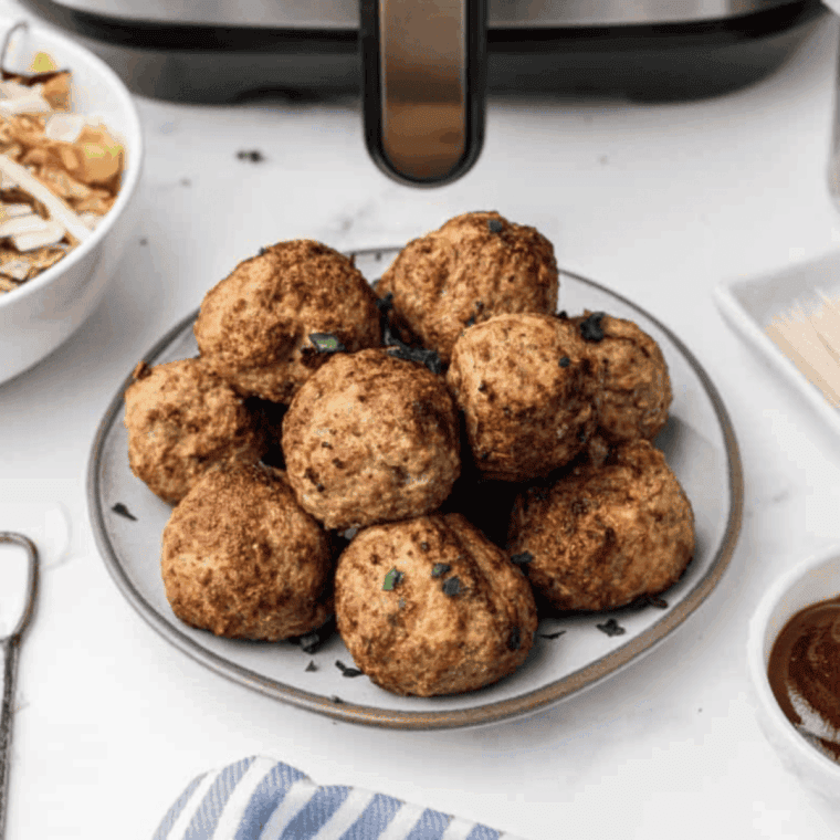 Spicy turkey meatballs garnished with fresh parsley, served on a plate, ready to eat.