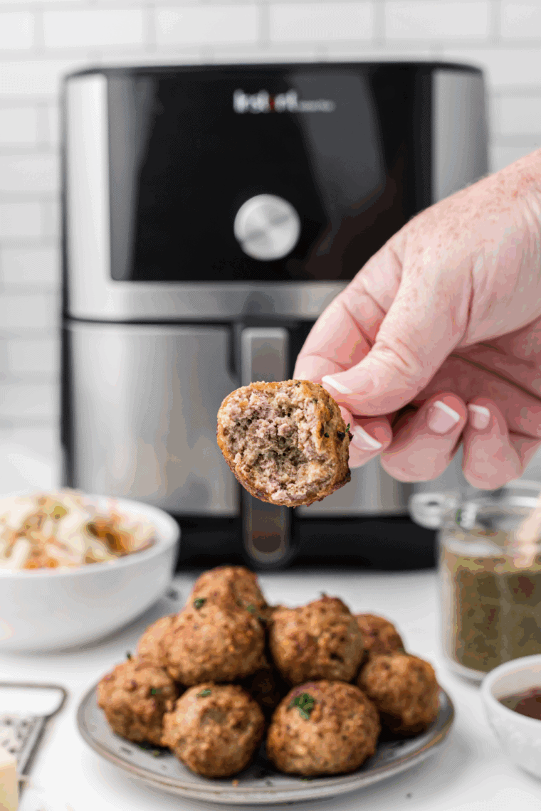 Juicy spicy turkey meatballs garnished with fresh herbs on a plate, ready to serve.