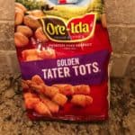bag of Ore-Ida frozen tater tots on a marble counter