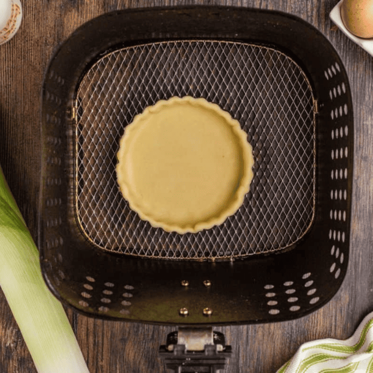 To make Air Fryer Caramelized Leeks and Artichoke Quiche, follow these steps: