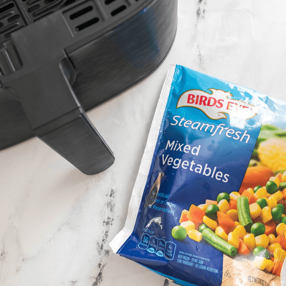 Ingredients needed for Air Fryer Frozen Vegetables on kitchen table.