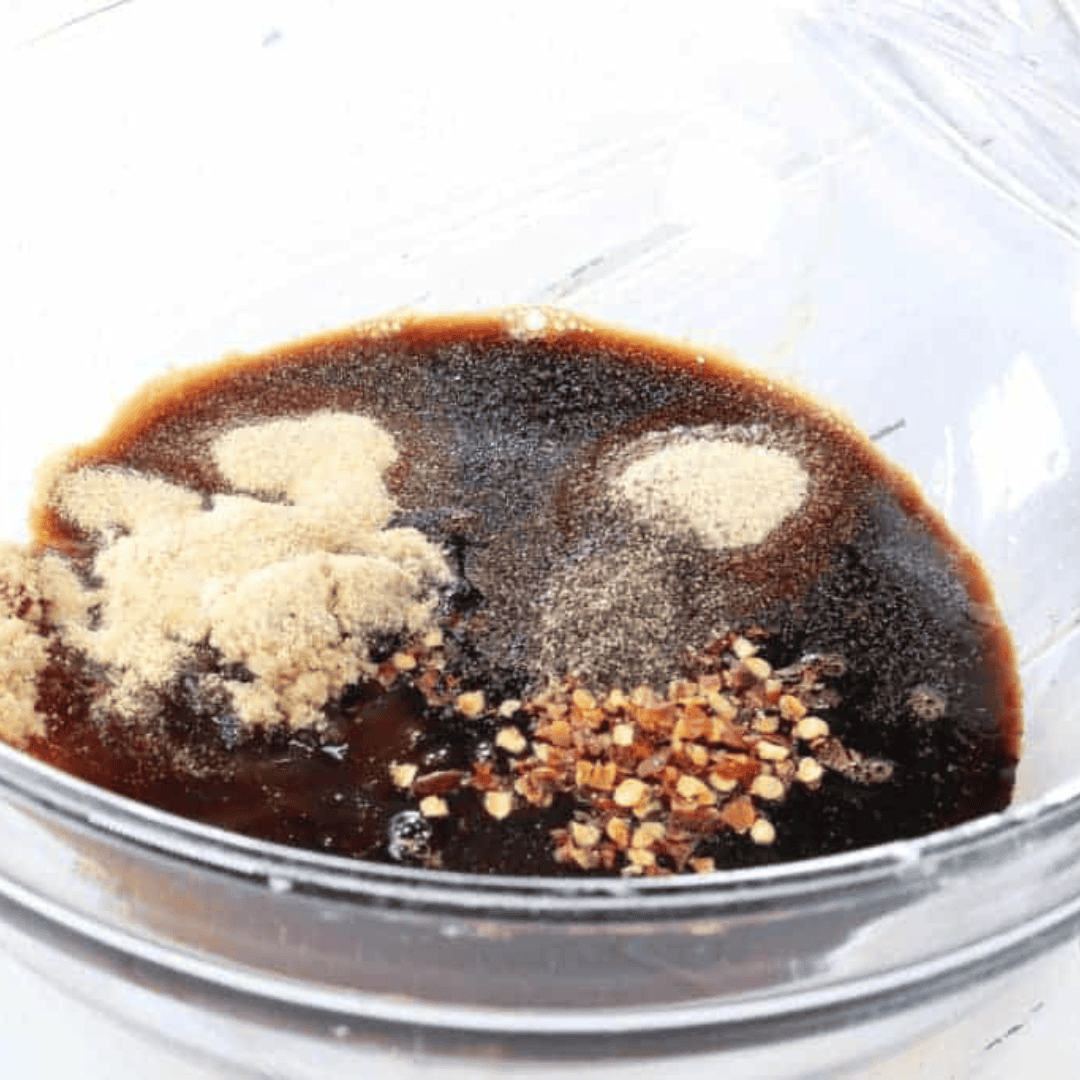 closeup: air fryer jerky marinade in a bowl with seasonings showing