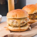 Crispy air fryer salmon burgers served on toasted buns with lettuce and sauce