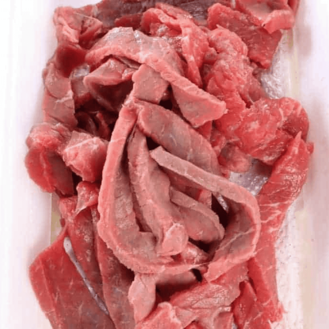 overhead closeup: raw beef cut into strips for my beef jerky air fryer recipe