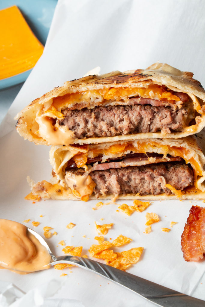 Air Fryer Cheeseburger Crunch Wrap filled with beef, bacon, tater tots, cheese, and Doritos, air fried to perfection.