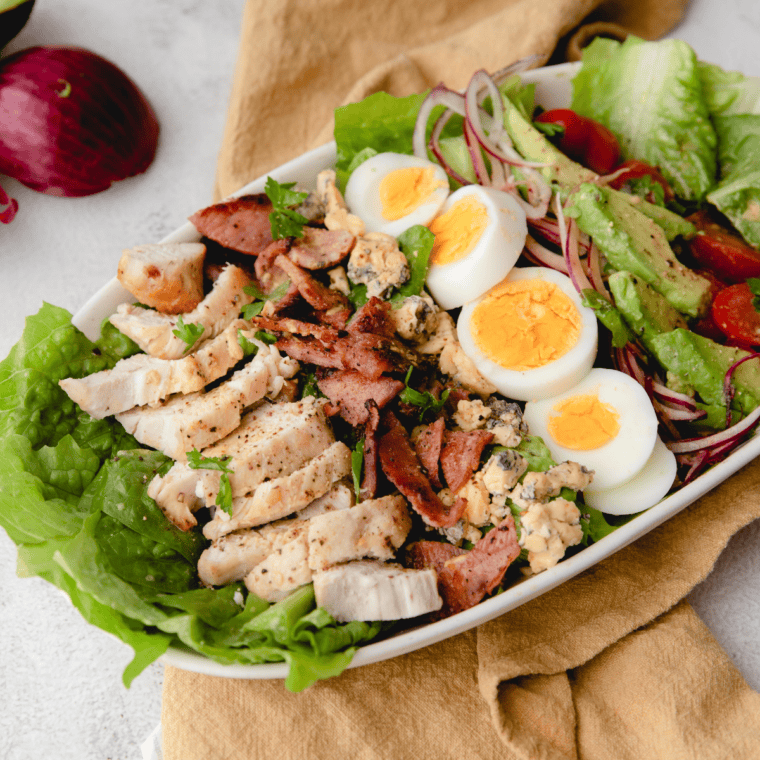 Air fryer Cobb salad topped with chicken, bacon, egg, and avocado
