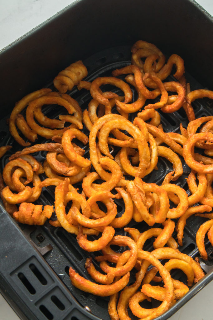 seasoned curly fries in air fryer basket