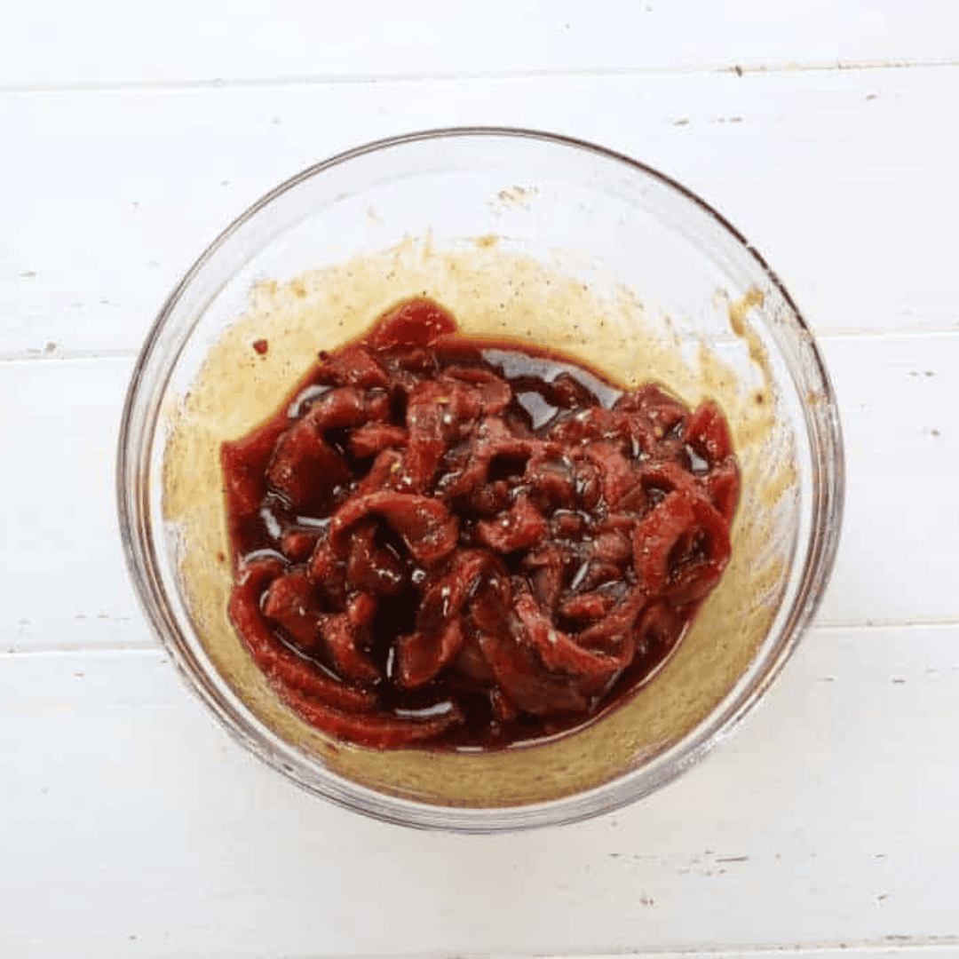 overhead: beef jerky marinating in bowl before air frying