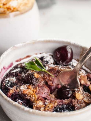 Cherry Oatmeal Breakfast in bowl, cooked with a spoon