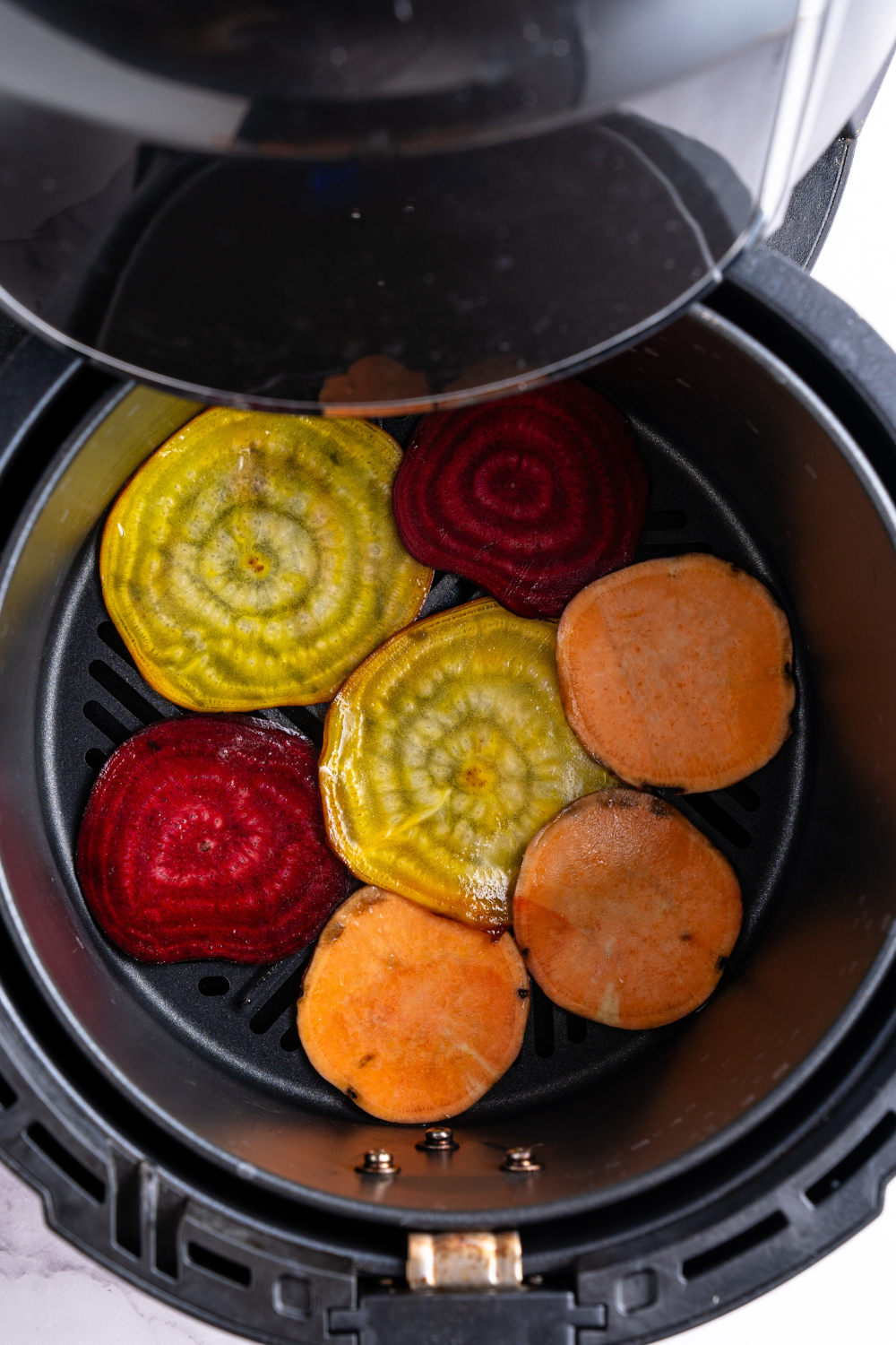 Place vegetable chips in the air fryer basket.