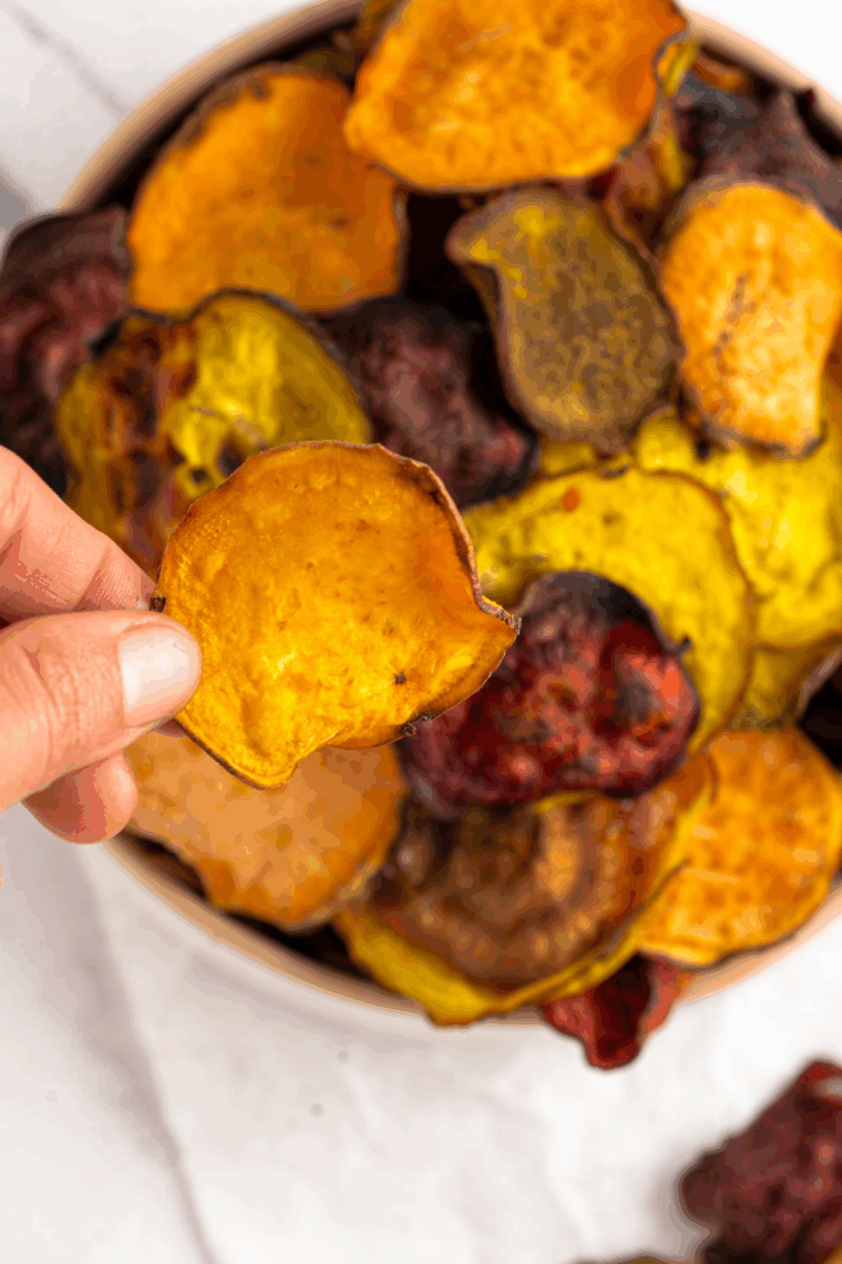 Crispy homemade Terra-style vegetable chips made in the air fryer, featuring colorful slices of sweet potatoes, beets, and purple potatoes on a serving platter.