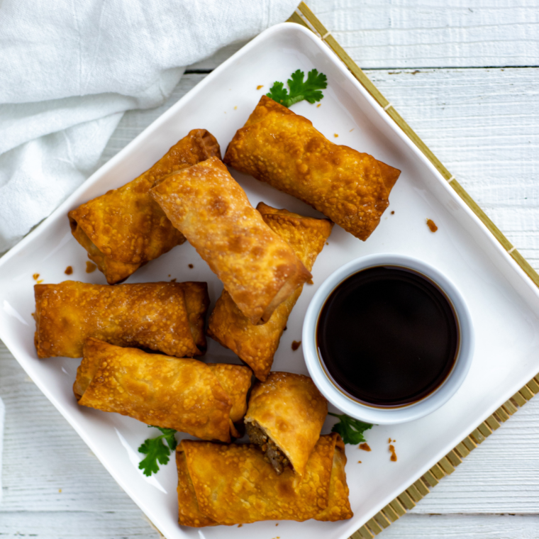 overhead closeup: a plate full of air fryer lumpia with dipping sauce