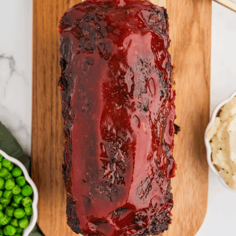 Air Fryer turkey meatloaf topped with ketchup glaze in a loaf pan, cooked and ready to serve.