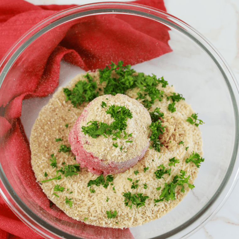 Ingredients for meatballs: ground beef, breadcrumbs, Parmesan, parsley, garlic, egg, salt, and black pepper in a large bowl.