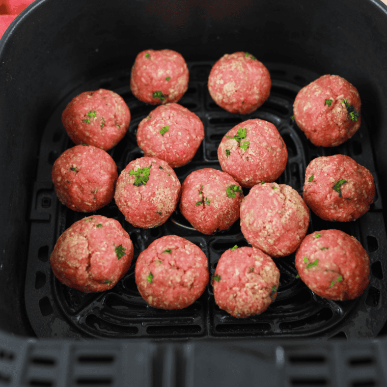 Placing meatballs in the air fryer basket, setting temperature to 350°F, and cooking for 8-10 minutes. Serving with marinara sauce or in a hoagie roll.