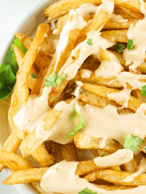 In-N-Out Spread copycat sauce served in a bowl with a spoon, next to fries and a burger.