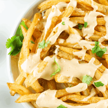 In-N-Out Spread copycat sauce served in a bowl with a spoon, next to fries and a burger.