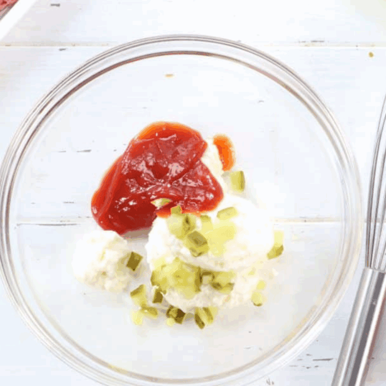 Small bowl with mayonnaise, ketchup, relish, vinegar, sugar, and salt being mixed together for In-N-Out Spread.
