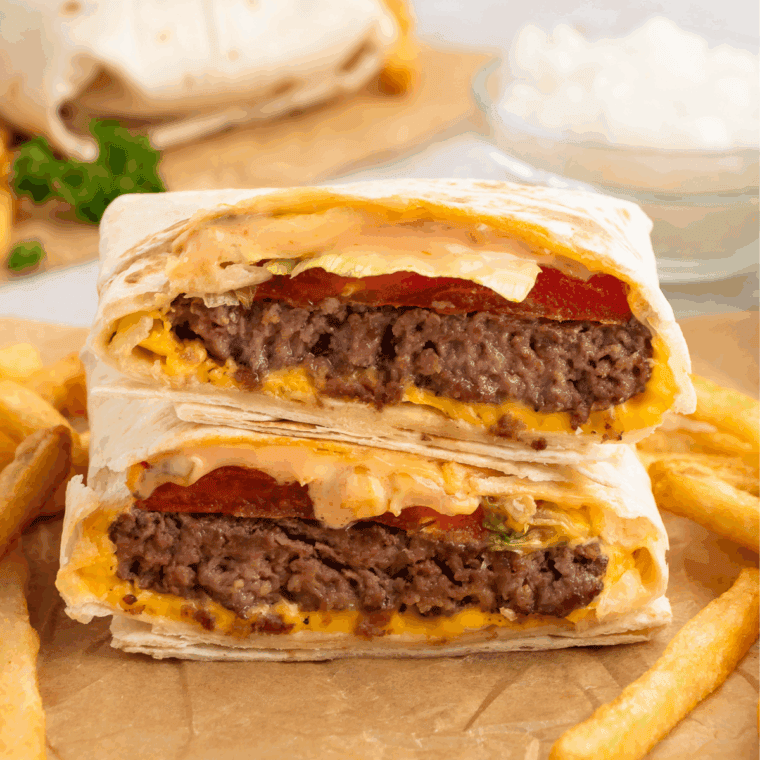 Creamy In-N-Out Spread copycat sauce in a bowl with a spoon, served next to fries and a burger.