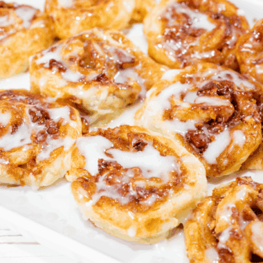 Freshly baked Panera-style cinnamon rolls topped with creamy icing.