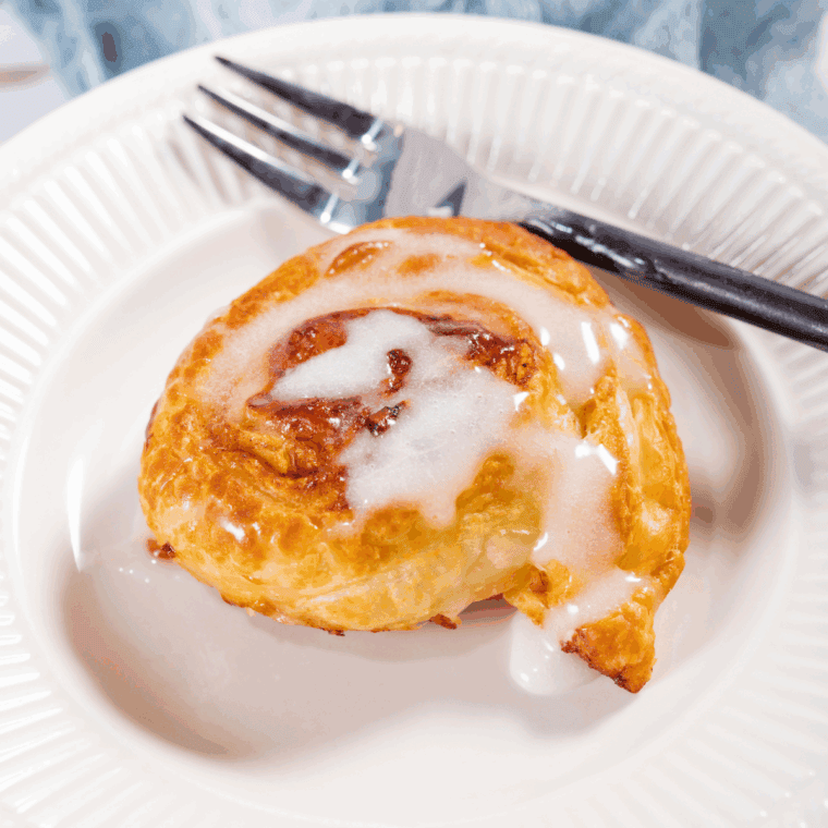 Flaky homemade cinnamon rolls inspired by Panera, topped with icing.