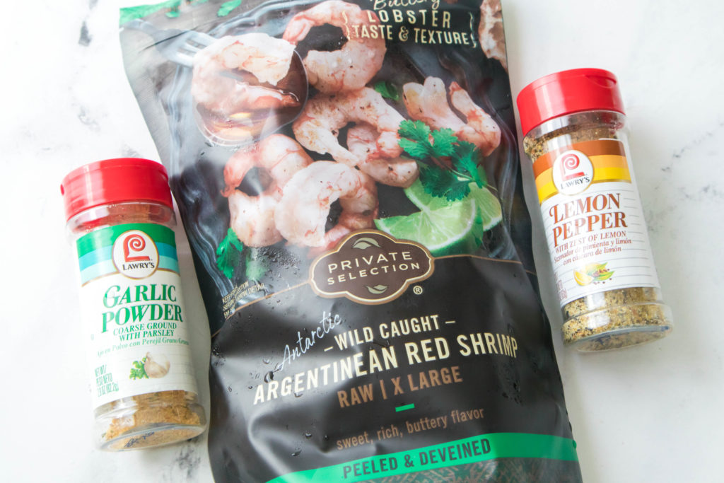 bag of frozen shrimp with bottles of garlic powder and lemon salt