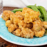 Plate of golden-brown Air Fryer Chinese Chicken Fingers served with dipping sauce.