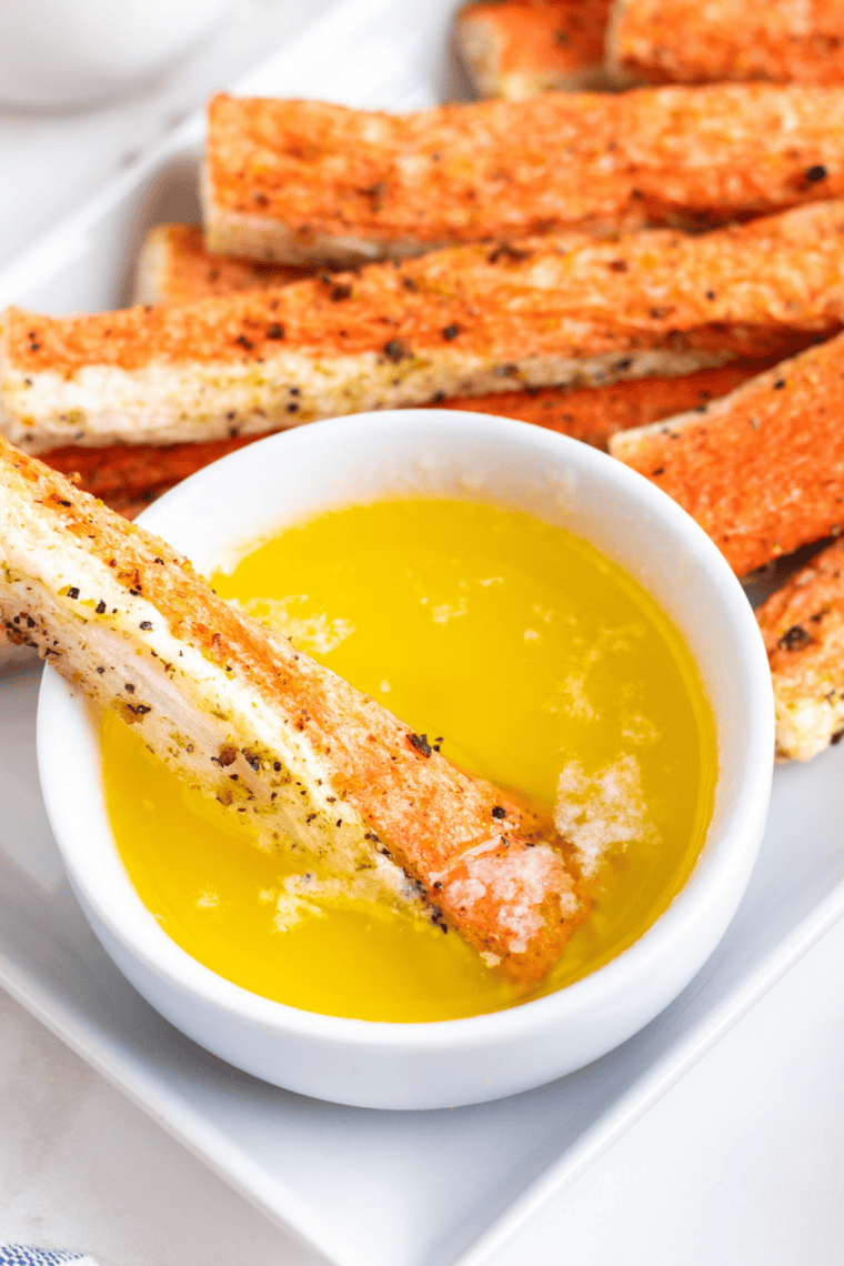 Crispy air fryer crab bites served with dipping sauce on a white plate