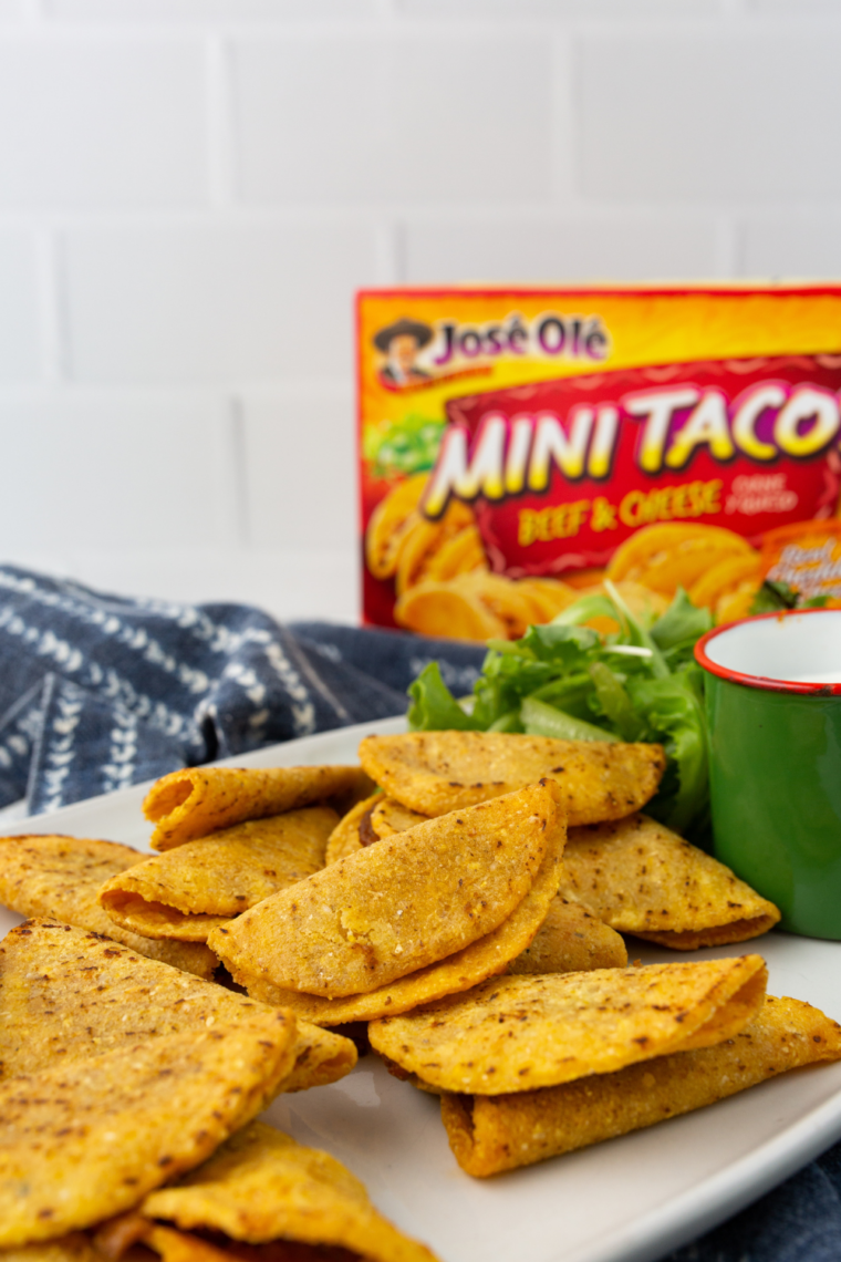 air fryer mini tacos resting on plate ready to serve with dipping sauces