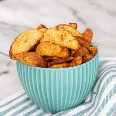 Crispy golden air fryer frozen potato wedges served in a white bowl