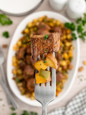 Close-up of tender steak bites alongside golden crispy potatoes