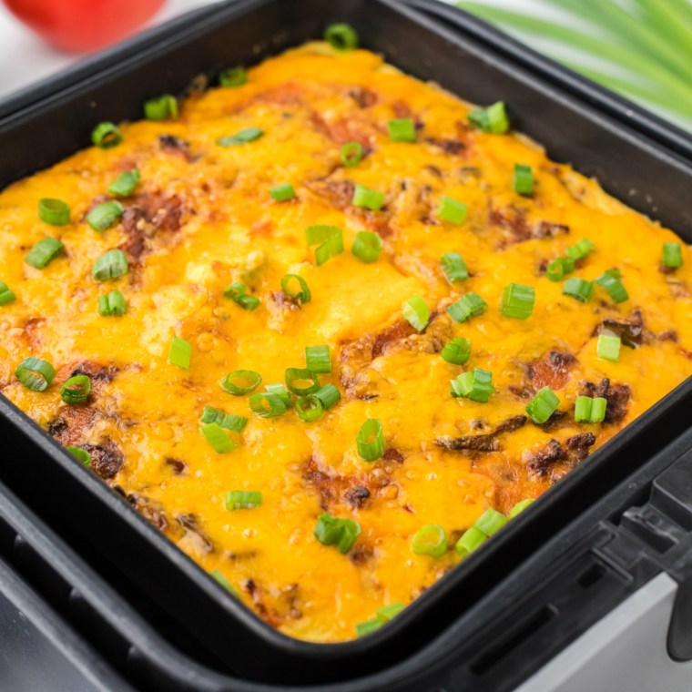 A hearty and cheesy Air Fryer Taco Casserole, featuring ground beef, bell peppers, tomatoes, and melted cheese, served as a comforting meal.