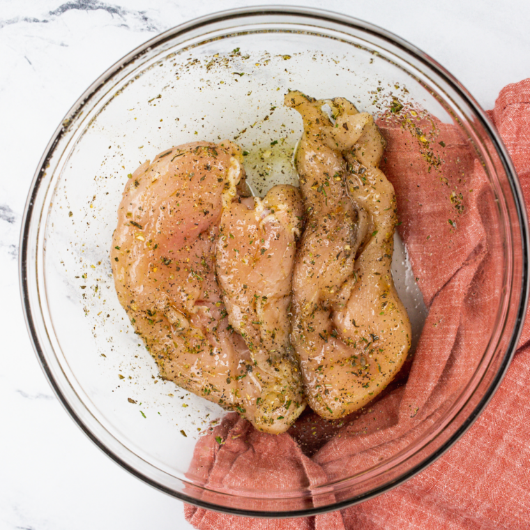 Season the chicken in the mixing bowl, and add your spices.