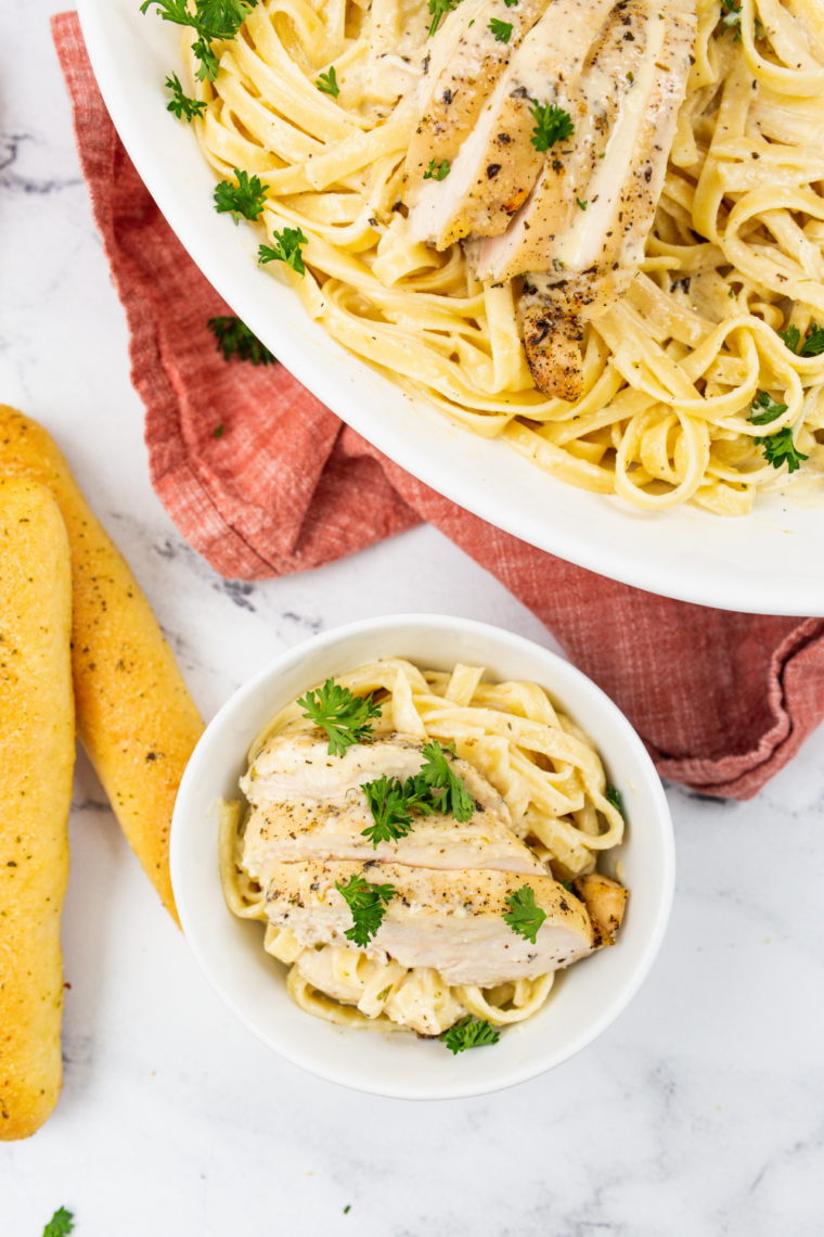 Plate of Applebee&rsquo;s Chicken Fettuccine Alfredo Copycat Recipe on the kitchen table.
