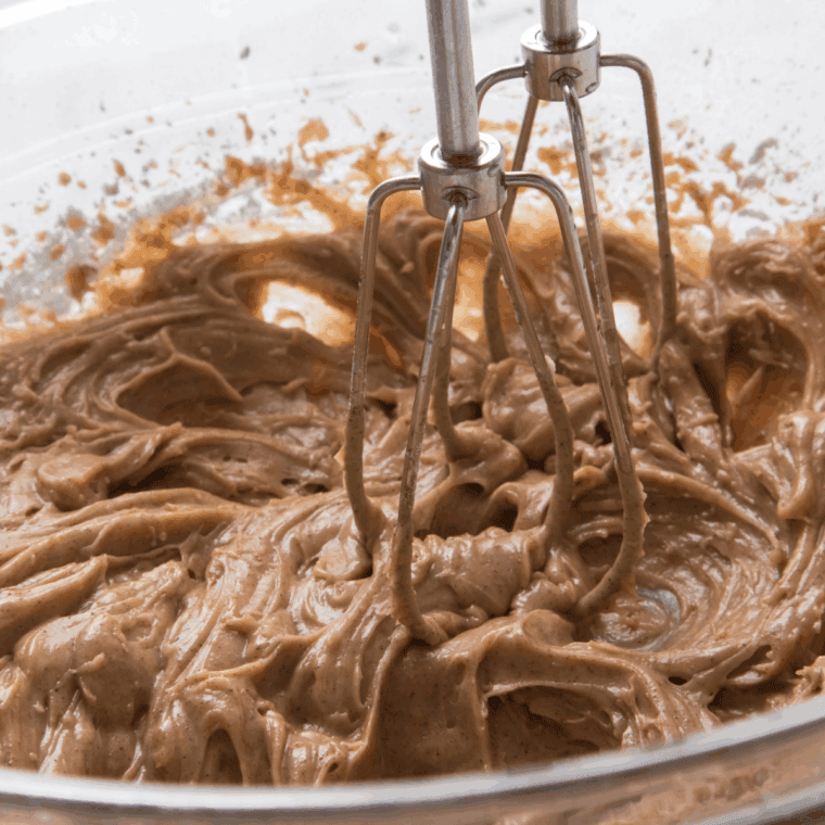Blending the ingredients with a hand mixer until smooth and creamy, then adjusting sweetness or cinnamon to taste.