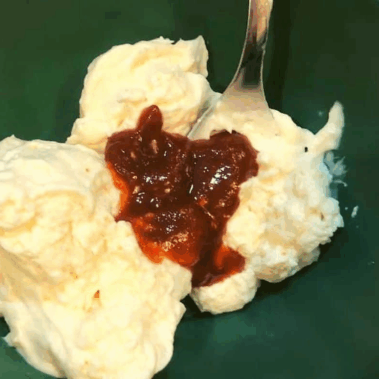 Mixing mayonnaise, sweet chili sauce, sriracha, and rice wine vinegar in a small bowl to make creamy Bang Bang Sauce.