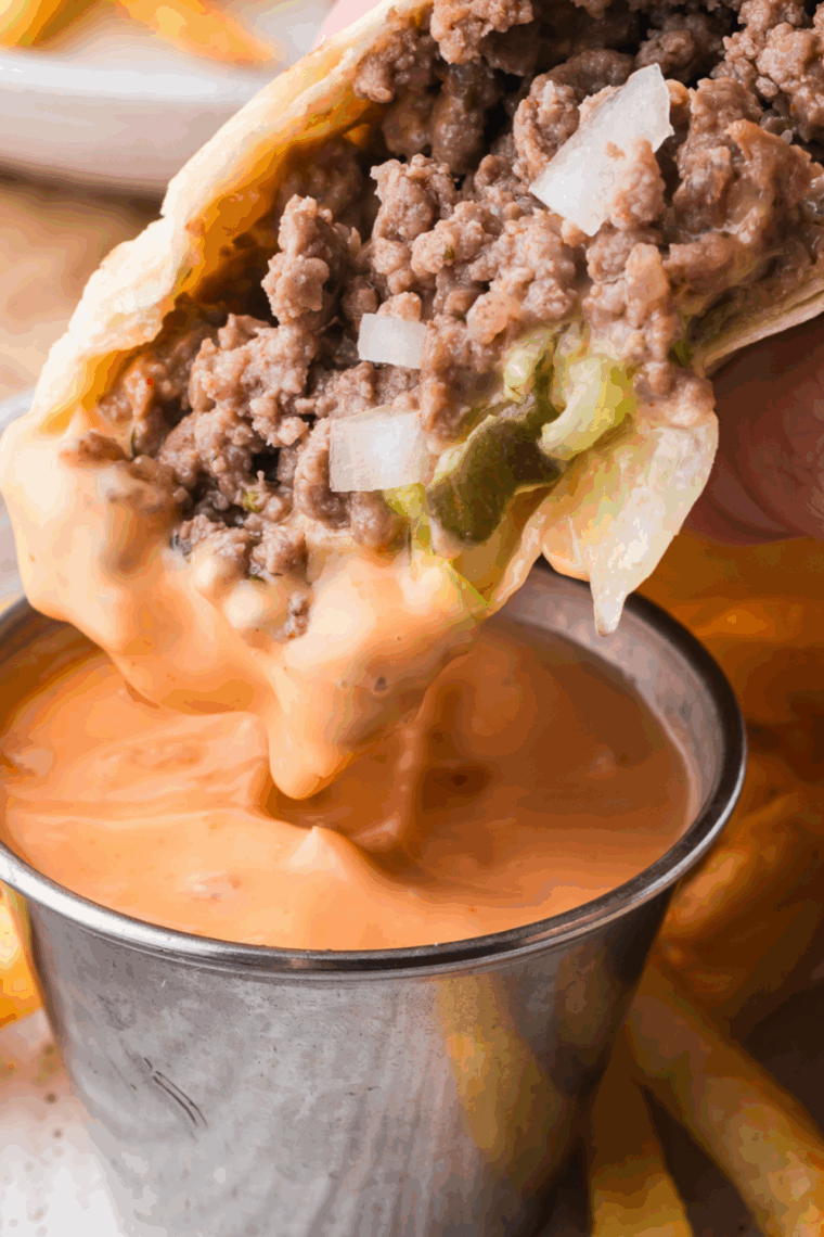 Creamy Big Mac copycat sauce in a small bowl with a spoon, surrounded by burger ingredients.