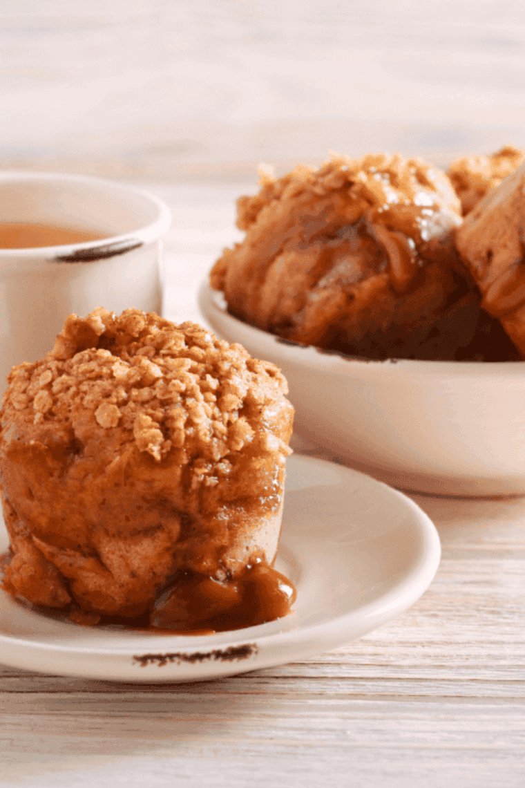 Golden air fryer caramel apple muffins with juicy apple pieces and caramel drizzle, freshly baked and ready to enjoy.