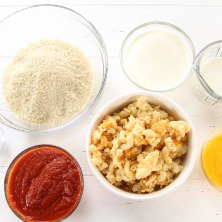 All of the ingredients for fried mac and cheese on table in individual bowls.