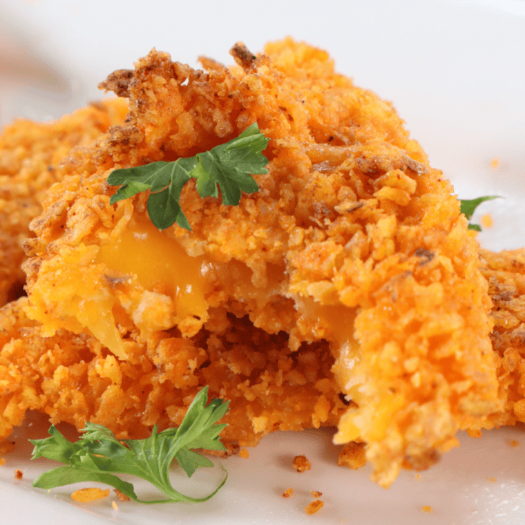 A plate of golden, crispy Air Fryer Cheesy Dorito Bombs with a crunchy Dorito crust.