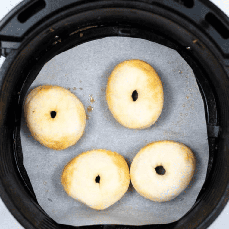 Placing dough circles in the air fryer basket for Copycat Hostess Powdered Donettes"