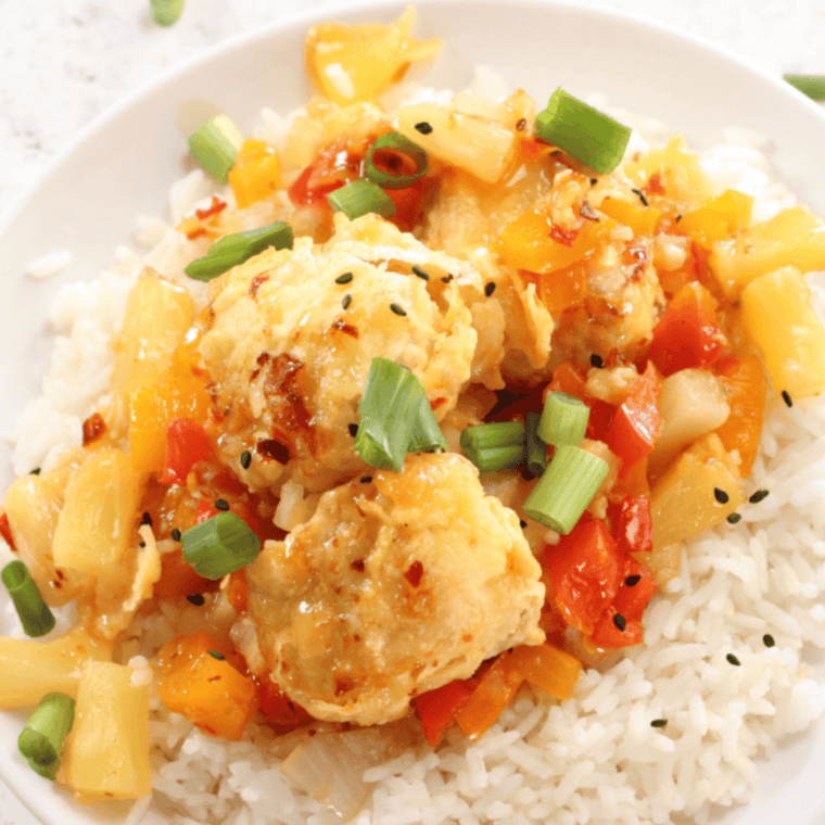 Plate of Air Fryer Panda Express Sweet Fire Chicken Copycat with crispy chicken pieces coated in sweet and spicy sauce.